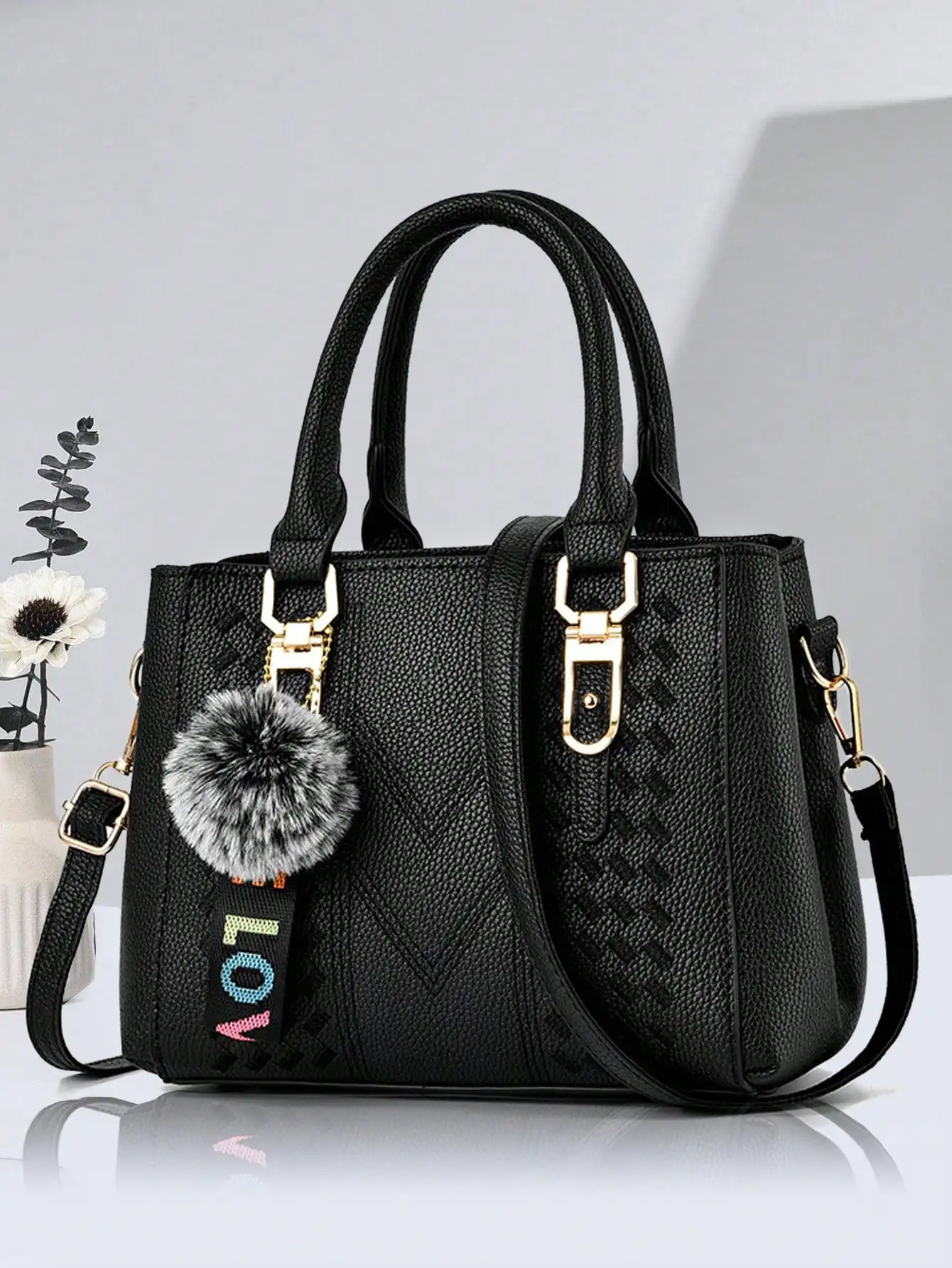 

Black Textured Top-Handle Handbag with Pom-Pom Charm and Adjustable Strap