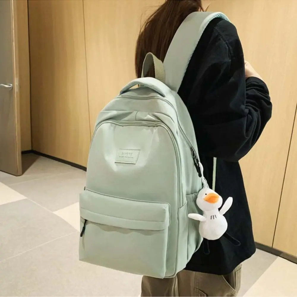 Presente pato pingente cor sólida mochila estilo coreano bolsa estudantes saco de armazenamento saco de ombro à prova dwaterproof água viagem