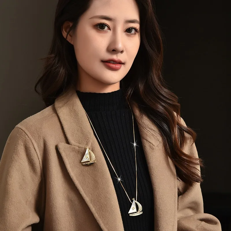 秋冬の新しいロングネックレス、セーリングボート風のセーターチェーン、ツーピースドレス用のコサージュブローチ