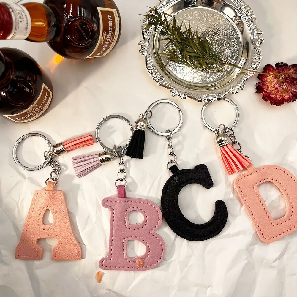 

Leather Keychain with 26 Letters Keychain High-end English Bag Pendant European and Leather Accessories Tassel Solid Color