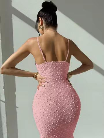 Elegant and romantic long dress for ladies with thin shoulder straps, a cinched waist and a slim figure, made of textured fabric