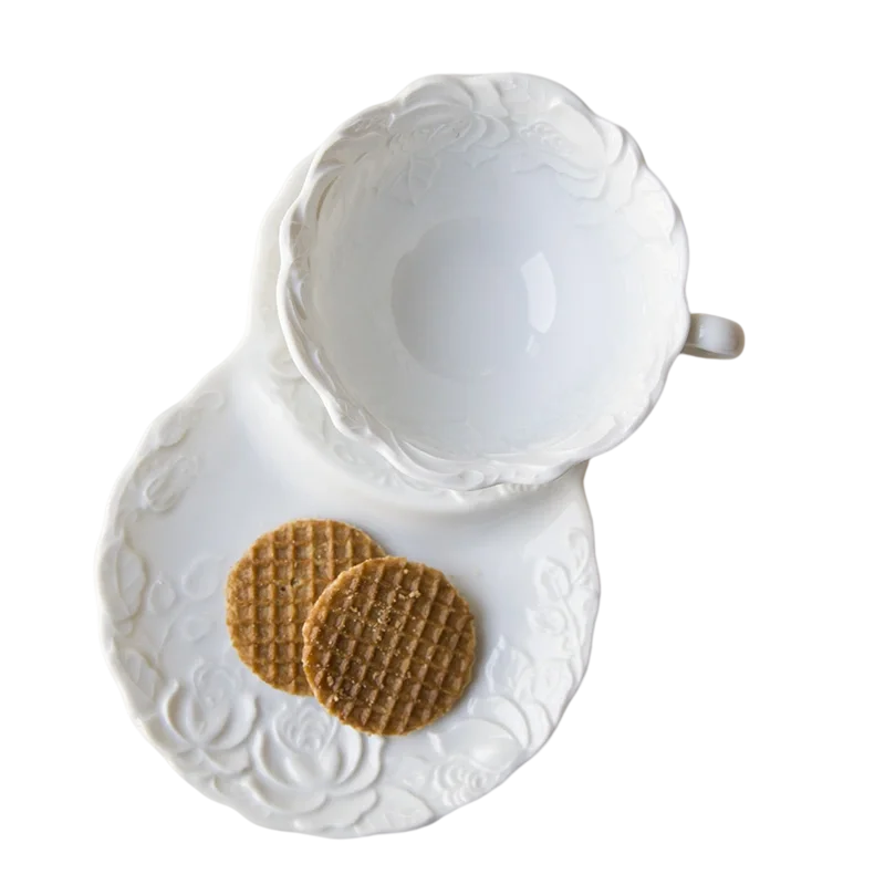 

White ceramic embossed rose coffee cup with irregular dessert plate