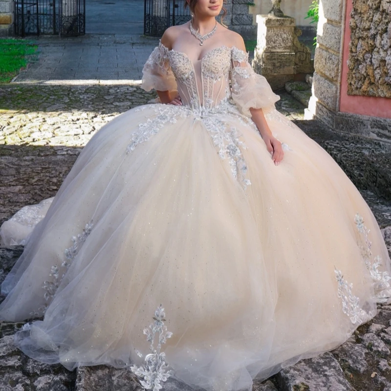 

Champagne Shiny Ball Gown Quinceanera Dresses 2026 Applique Lace Beading Crystal Bow Tull Corset Off Shoulder Sweet 16 Dress Yea