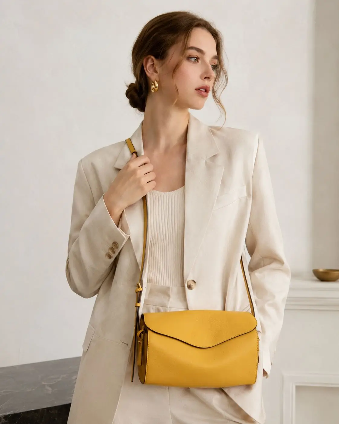 

Bright yellow leather crossbody bag with minimalist envelope flap, adjustable strap, and sleek rectangular silhouette.