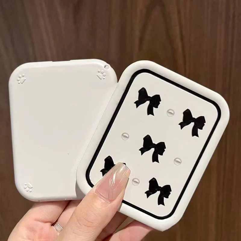 Miroir de maquillage rectangulaire portable avec design à nœud papillon rabattable et peigne intégré – Miroir cosmétique compact pour femme