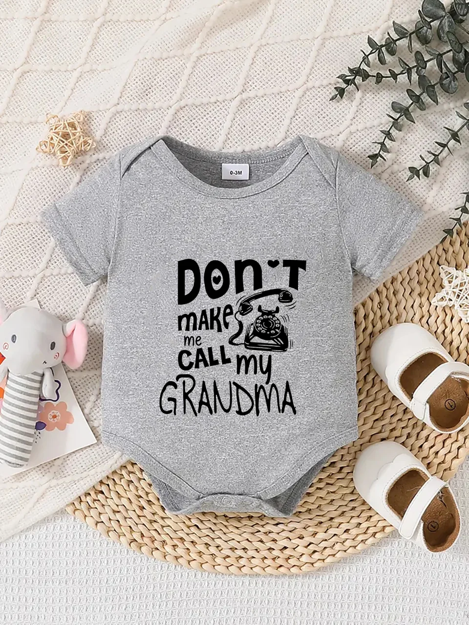 Playful letter-printed baby short-sleeve triangle bodysuit. Button closure for easy dressing
