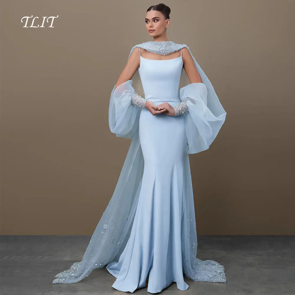 فستان سهرة أنيق من TLIT باللون الأزرق والحرير والساتان حورية البحر مع سترة من التول وأكمام منتفخة وقطار سويب كريستالي مع كريستالفساتين