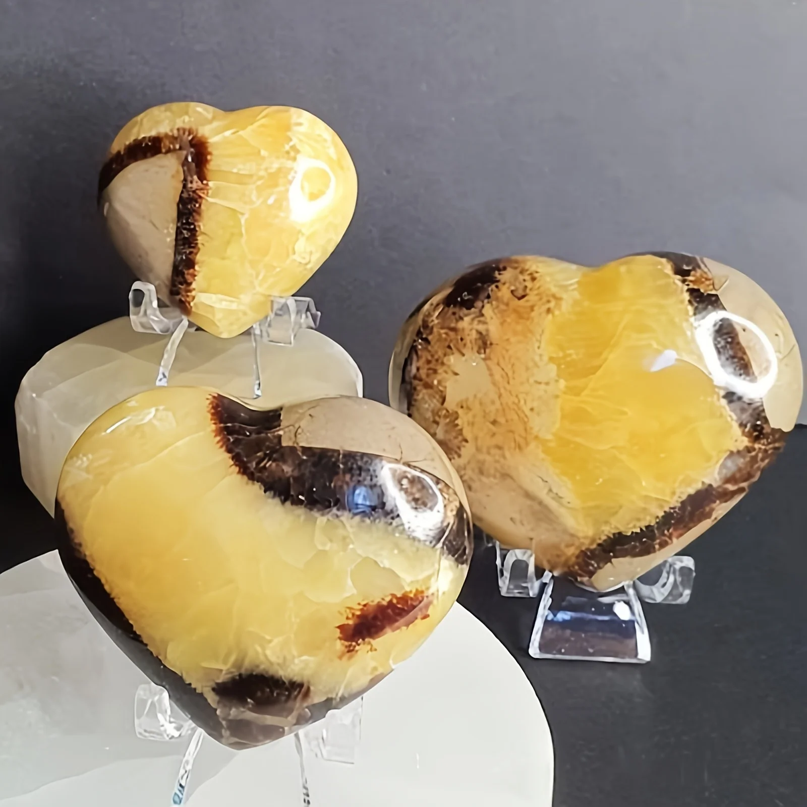 An elegant, high-quality polished yellow tortoiseshell quartz heart, suitable for home décor and educational display