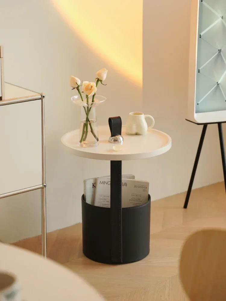 A few household small apartments by the sofa, simple round living room,hand-carried coffee table, and a mobile corner table