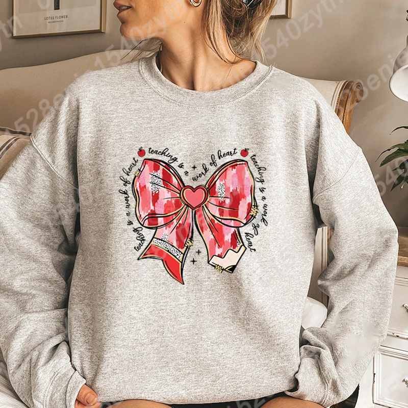 New Fashion Women's Long Sleeve Hoodless Pullovers Valentine's Day Bow Teaching Is A Work Of Heart Graphic Round Neck Sweatshirt