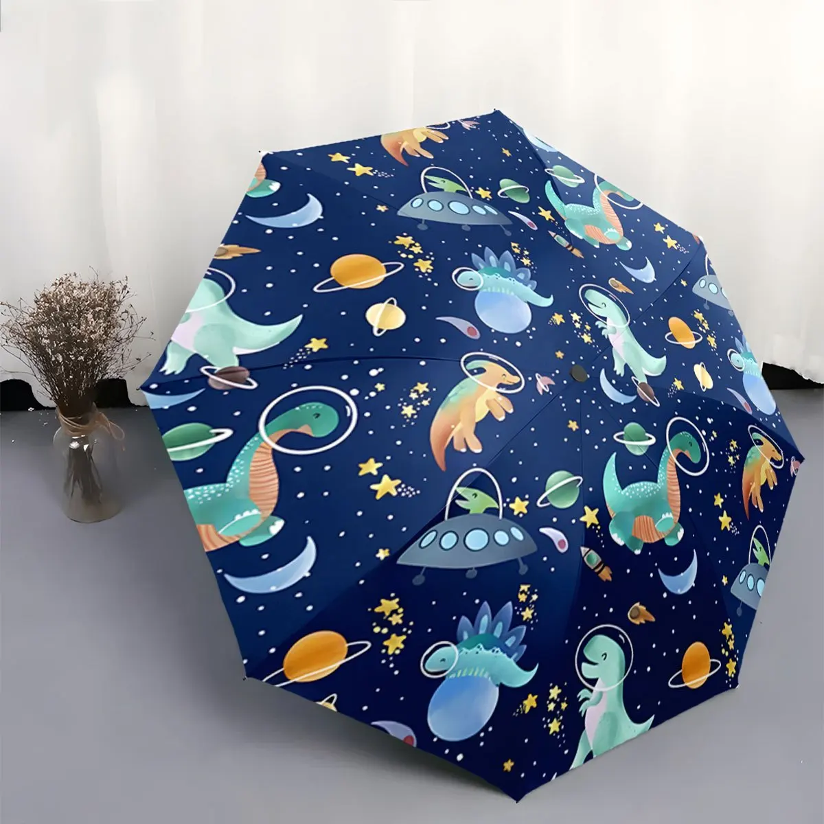 

Automatic Folding Umbrella Dinosaurs in space-themed designs. Portable collapsible design, casual outdoor accessory, Christmas