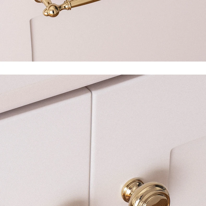 Coordinating round gold knobs on a white cabinet