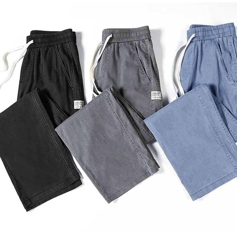 Celana jeans pria musim panas, model longgar potongan lurus, pinggang elastis dengan tali serut, gaya kasual Korea, ukuran besar M-5XL
