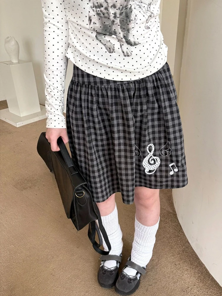 

2026 New Y2K Black Plaid Mini Skirt Women Design Sense Music Note Sweet Pleated Skirts Japanese Retro Slim Pretty Clothes Spring
