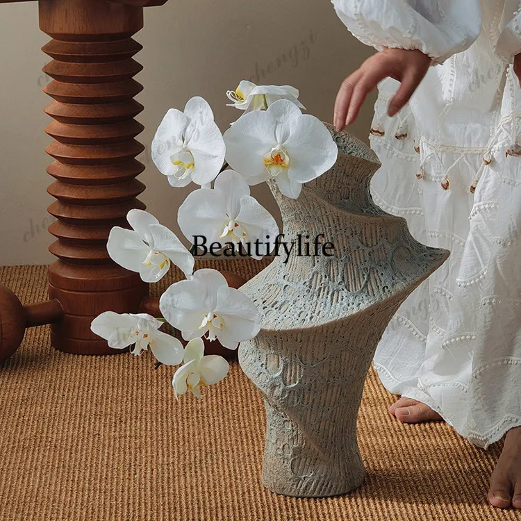 Artists, sculptures, woven shadows, flowing sand, handmade ceramic vases,  living rooms, and dining rooms, soft decorations