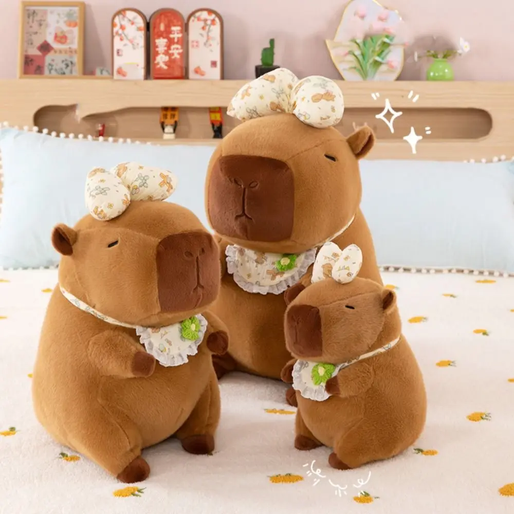 

Милая плюшевая кукла капибара с бантом, имитация пушистой капибары, плюшевая игрушка, мягкая мультяшная пушистая кукла капибары, рождественская игрушка