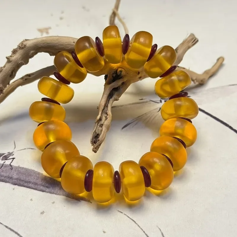

An elegant rare egg yolk amber flat bead bracelet in Bohemian style