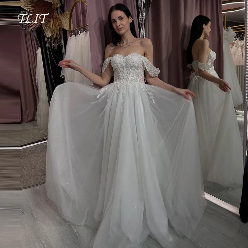 فساتين زفاف TLIT الفاخرة من التول الأبيض مخصصة على شكل قلب مزينة باللؤلؤ الكريستالي قبالة الكتف مشد زي العرائس #1