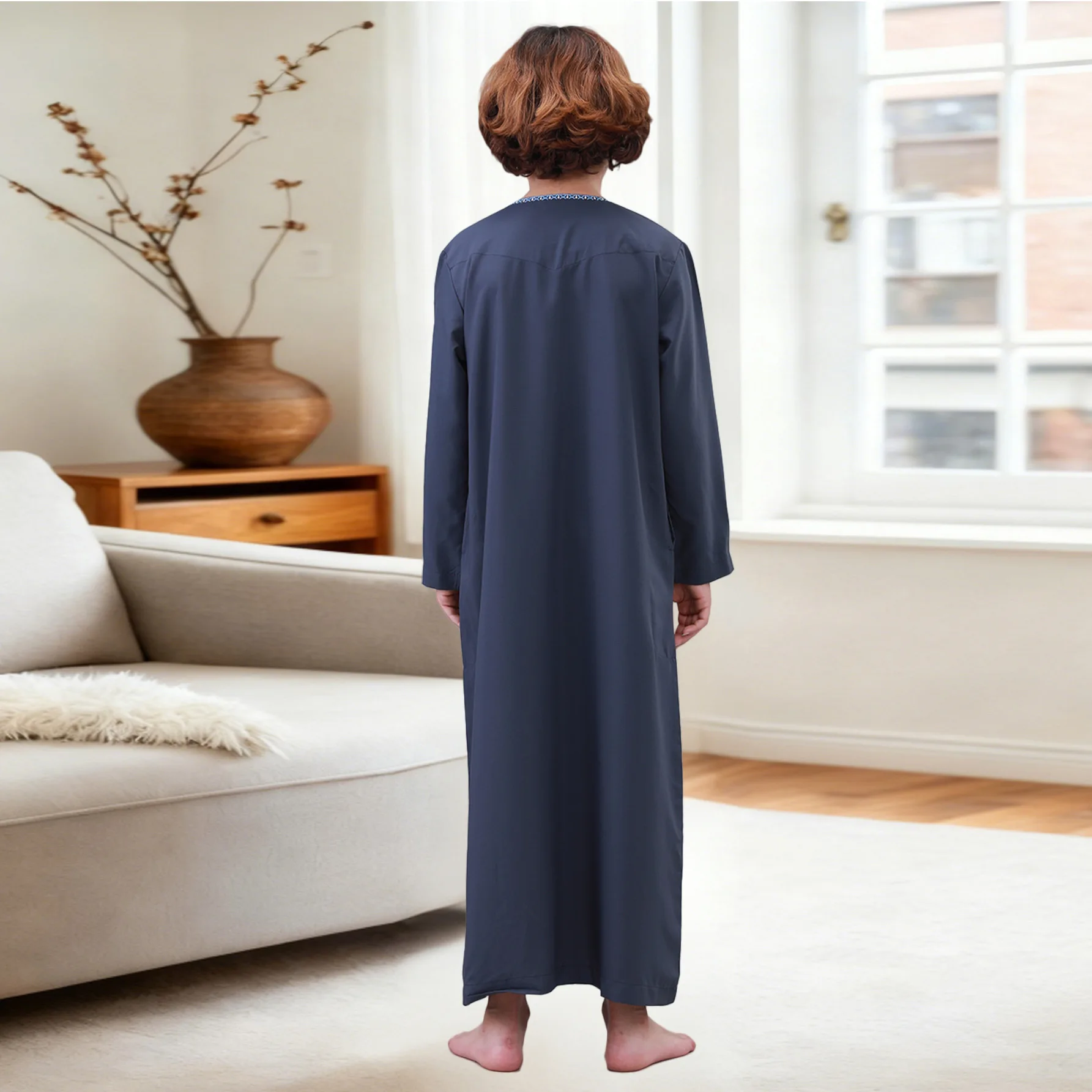 Back view of a boys' jubba thobe, showcasing its full-length design and fabric texture.