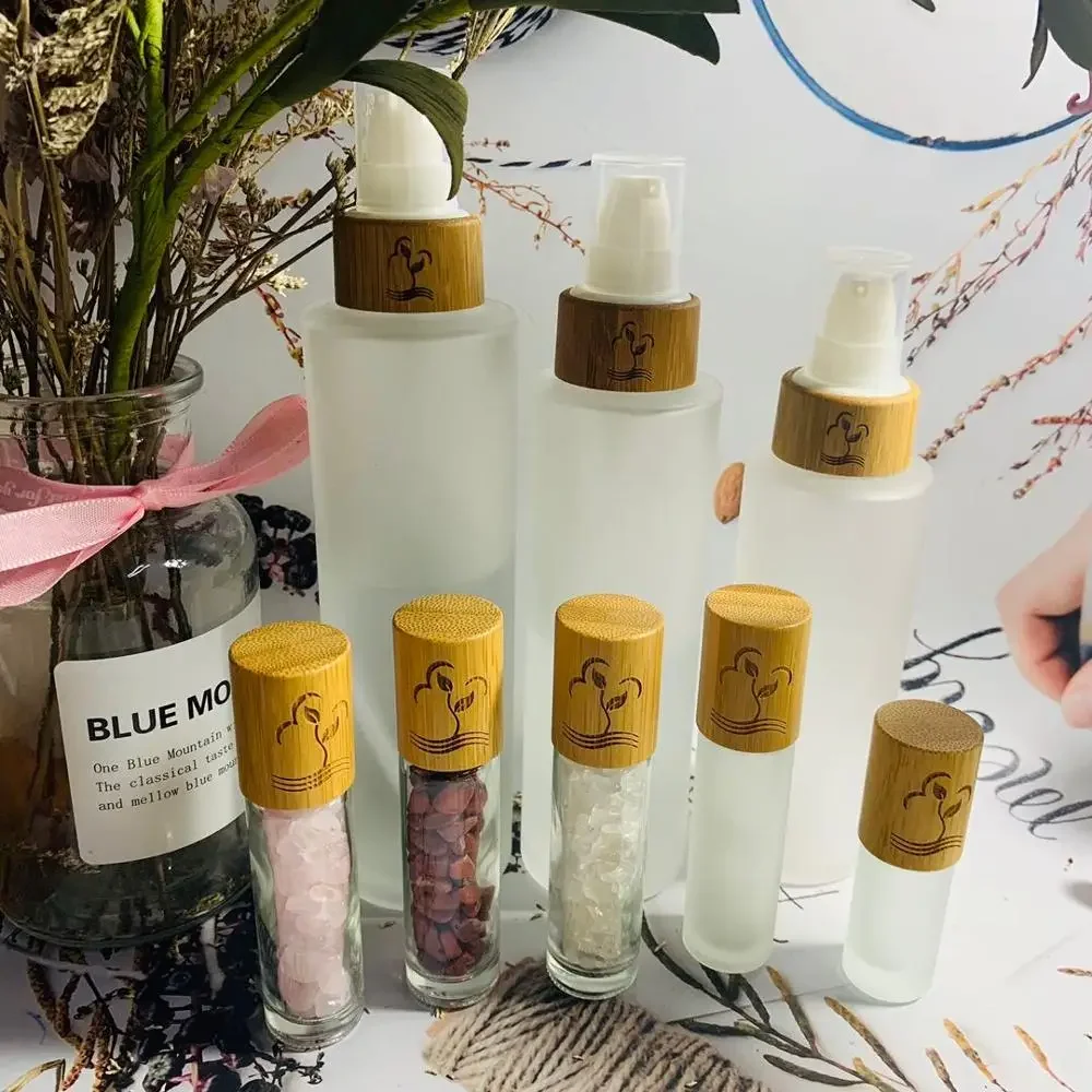 

selling empty engraving logo frosted glass bamboo bottles with lotion cap skin care shampoo bottles cosmetics packaging bottle