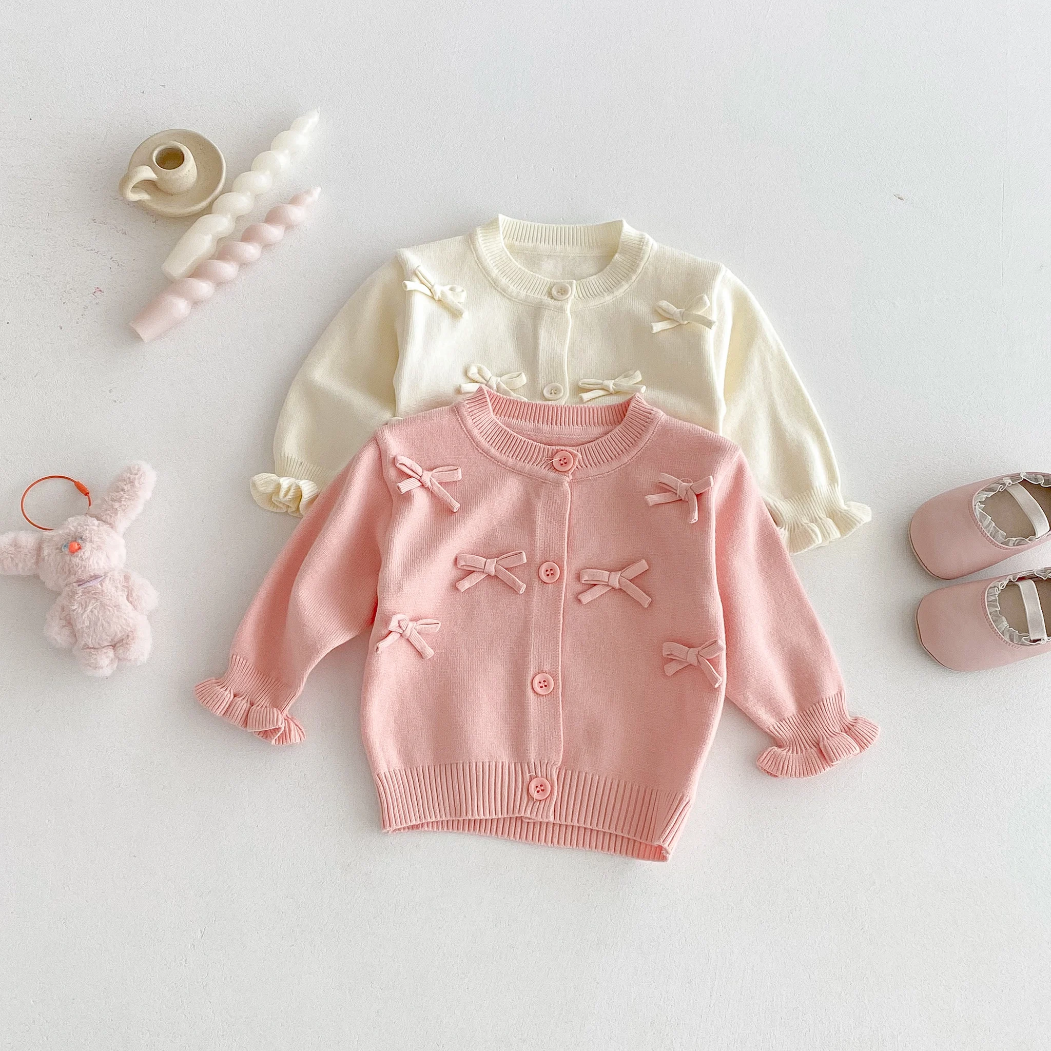 A Cute Long-Sleeved Cardigan with a Bow for a Baby Girl in Autumn