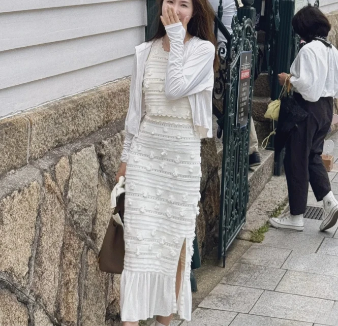 

Женский белый вязаный костюм-двойка с жилетом без рукавов с круглым вырезом или эластичной юбкой миди.