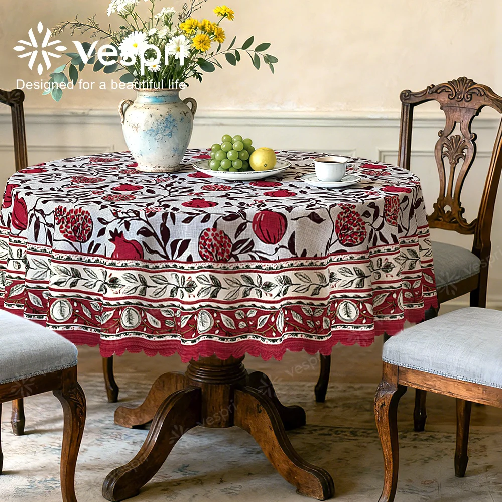 Vespri Spring Tablecloth, with white and red decorations, featuring pomegranates and green leaves, circular shape.