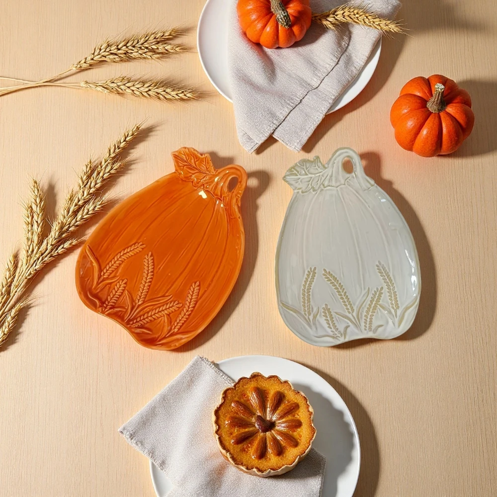 Handmade ceramic pumpkin plate with wheat embossed relief to decorate rustic pottery for autumn table setting