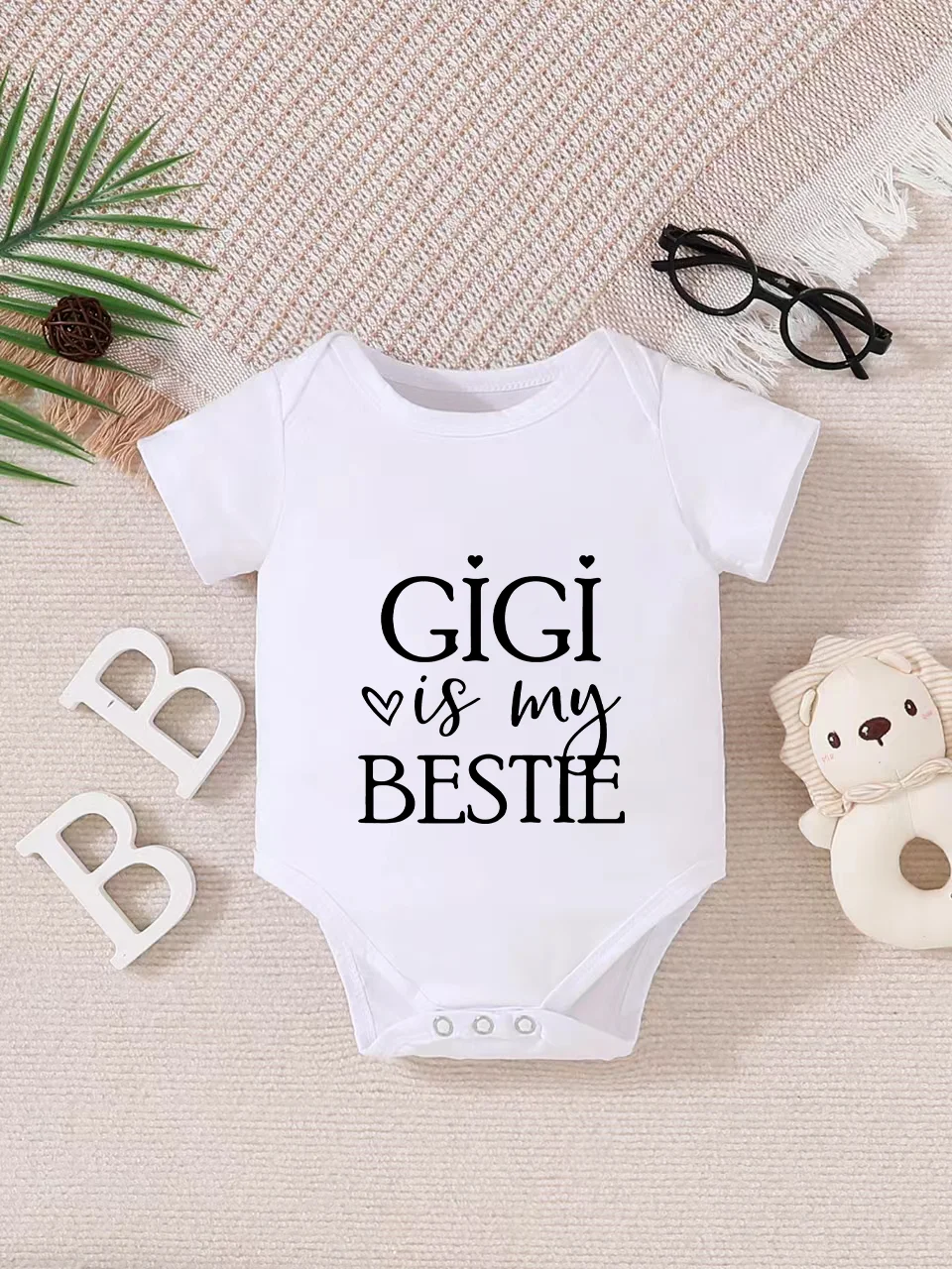 

Playful letter-printed baby short-sleeve triangle bodysuit. Button closure for easy dressing, machine washable