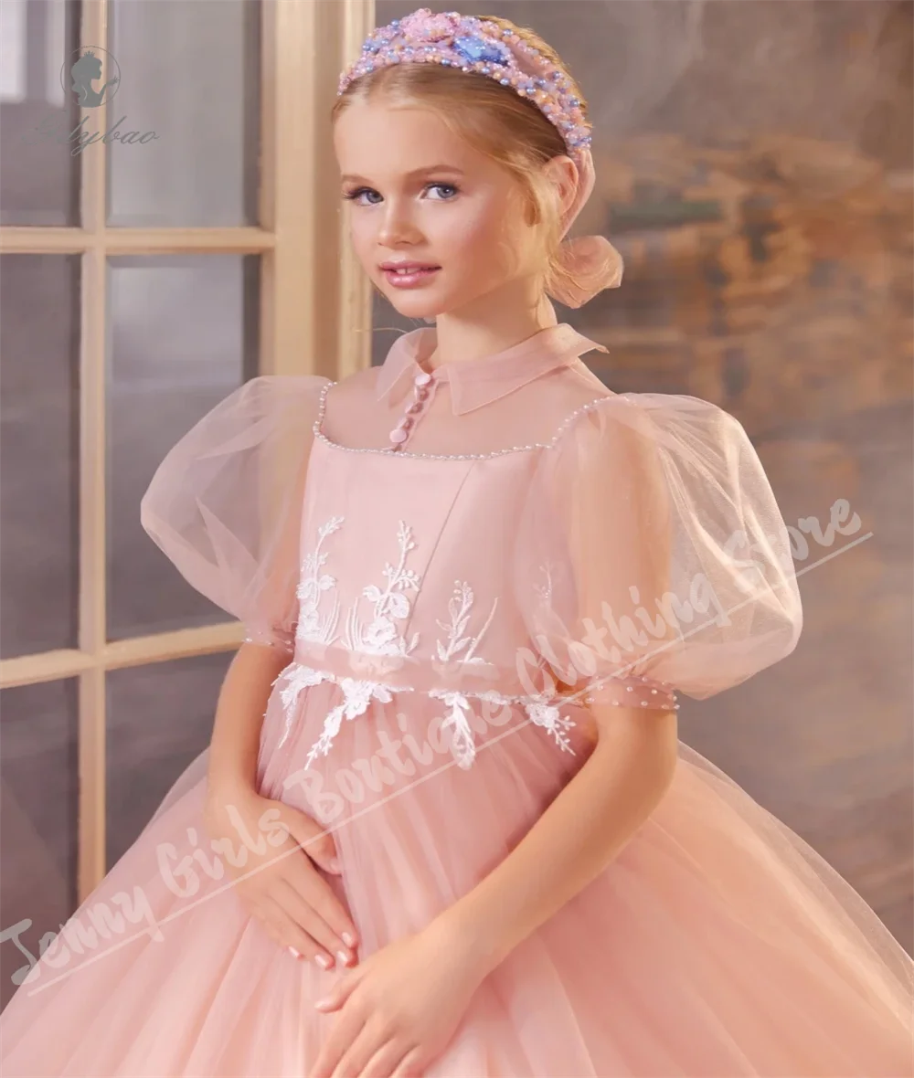 ชุดเจ้าหญิงหลอนสีชมพูที่มีเสน่ห์พร้อมแขนสั้นหวานปุยเด็กชุดวันเกิดสำหรับงานแต่งงาน