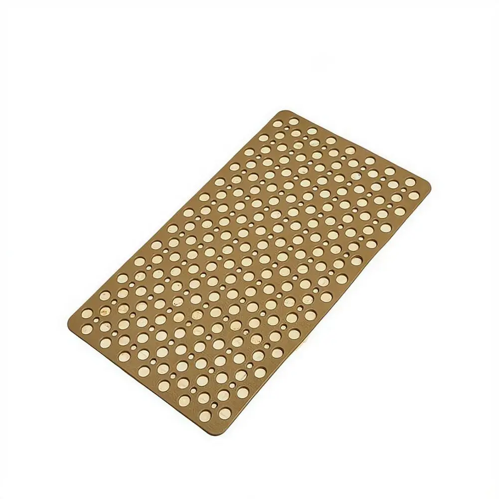 Blue bath mat with suction cups and massage bumps on a wet tile floor.