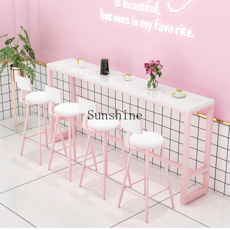 

Milk tea shop against the wall high bar simple table and chair combination