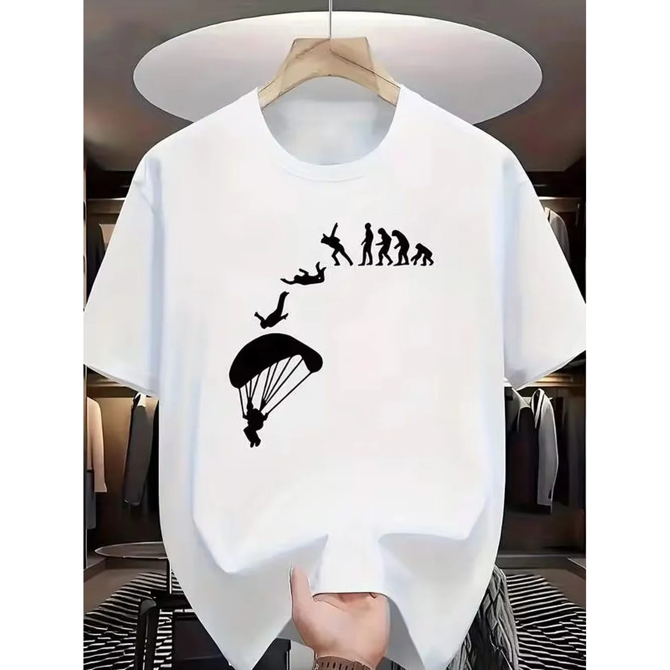 A Round-Neck Short-Sleeve T-Shirt Featuring A Creative Silhouette Design That Combines The Human Evolution Chain With Skydiving. The Overall Design Is Infused With The Of Extreme Sports And The Fun Of Evolution