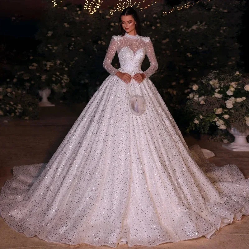 فستان زفاف أنيق لامع مخصص مطرز بالخرز والدانتيل والترتر فستان عروس برقبة عالية وأكمام طويلة فيستدو دي نوفيا