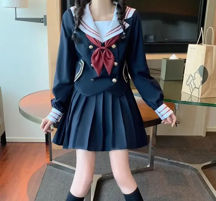 Le ragazze dell'uniforme scolastica giapponese vestono il vestito da marinaio primaverile
