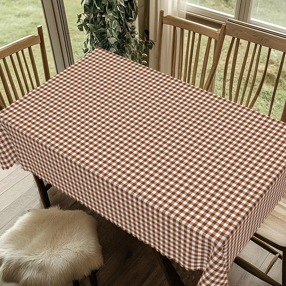 One beige and brown checkered tablecloth - a heavy rectangular table covering.