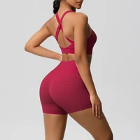 Women’s red cross-back sports bra and high-waisted gym shorts set