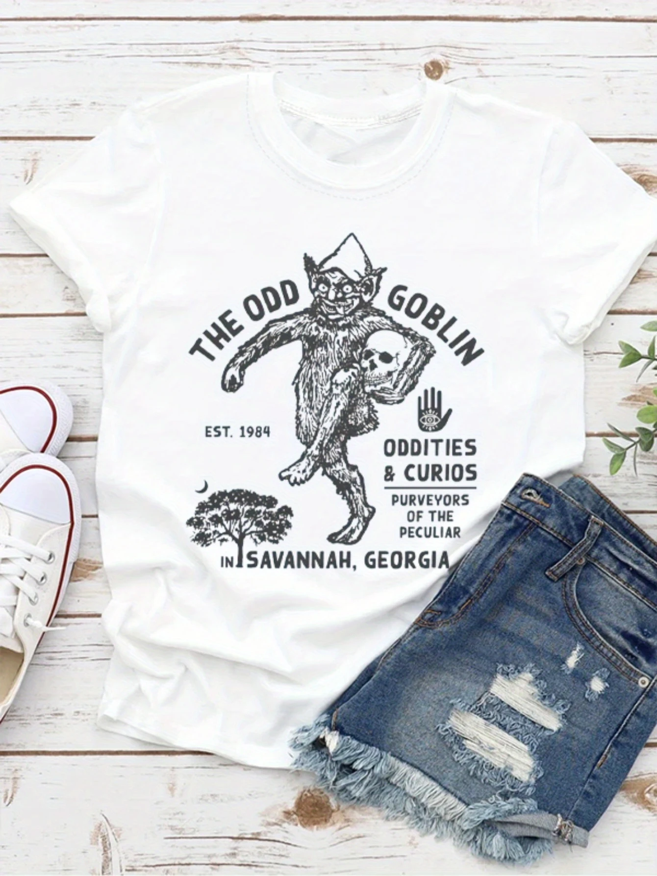 

The Odd Goblim Slogan Women T-shirt Horror A Goblin with A Skull in His Hand Print Female Shirt 2024 New Voguish Casual Girl Tee