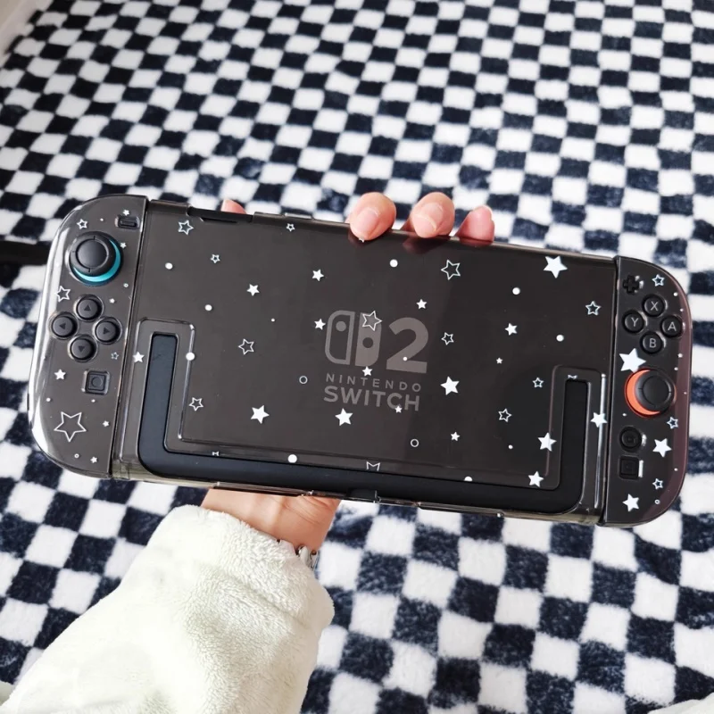 �y�Z�[�����z�I���W�i���f�U�C�� Switch2 �ی�V�F���؍� Y2k �K�[�����󍕂Ɣ��̋P���n�[�h�V�F���A�j���Q�[�����Ӌ@��