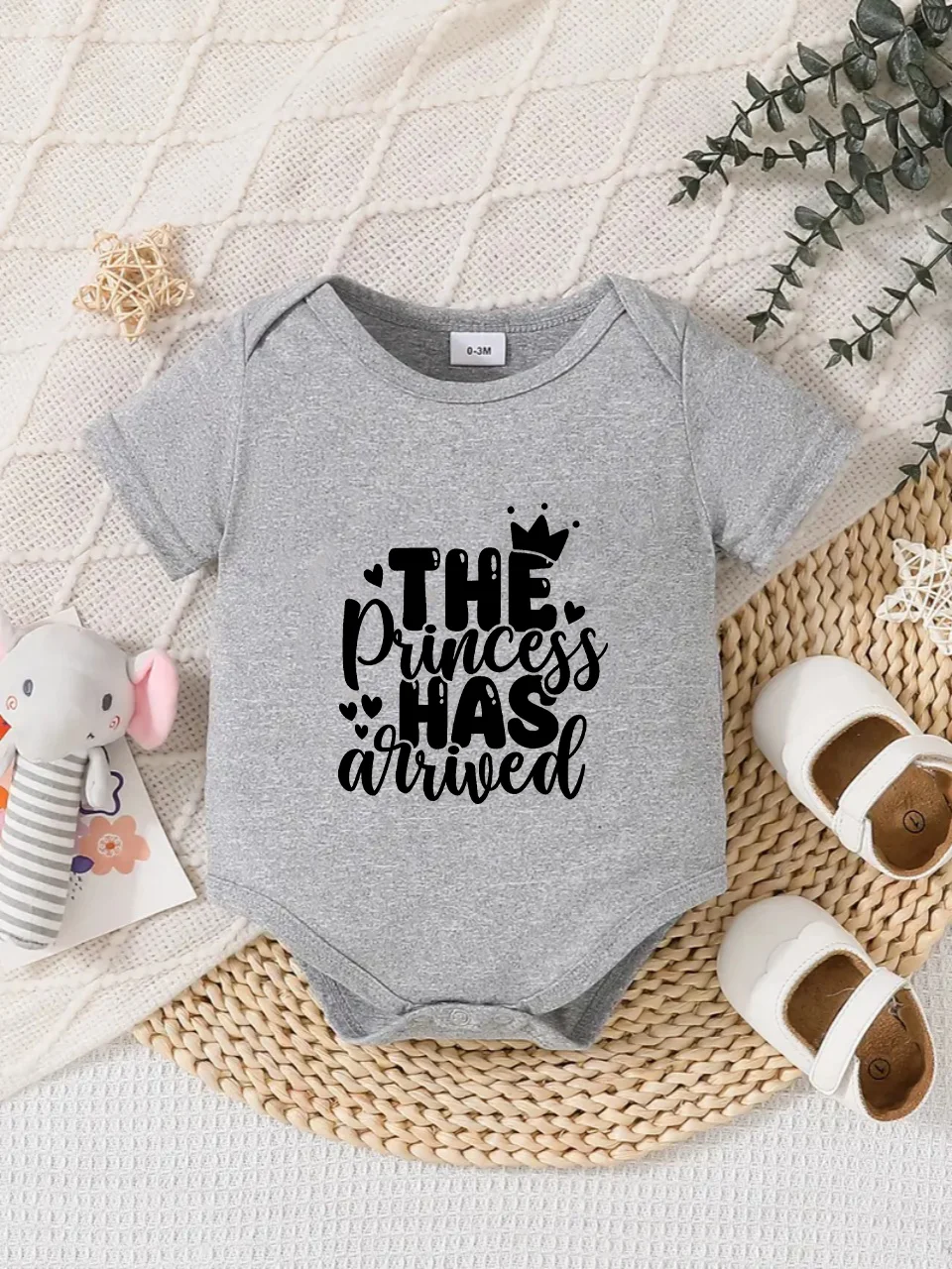 Playful letter-printed baby short-sleeve triangle bodysuit. Button closure for easy dressing