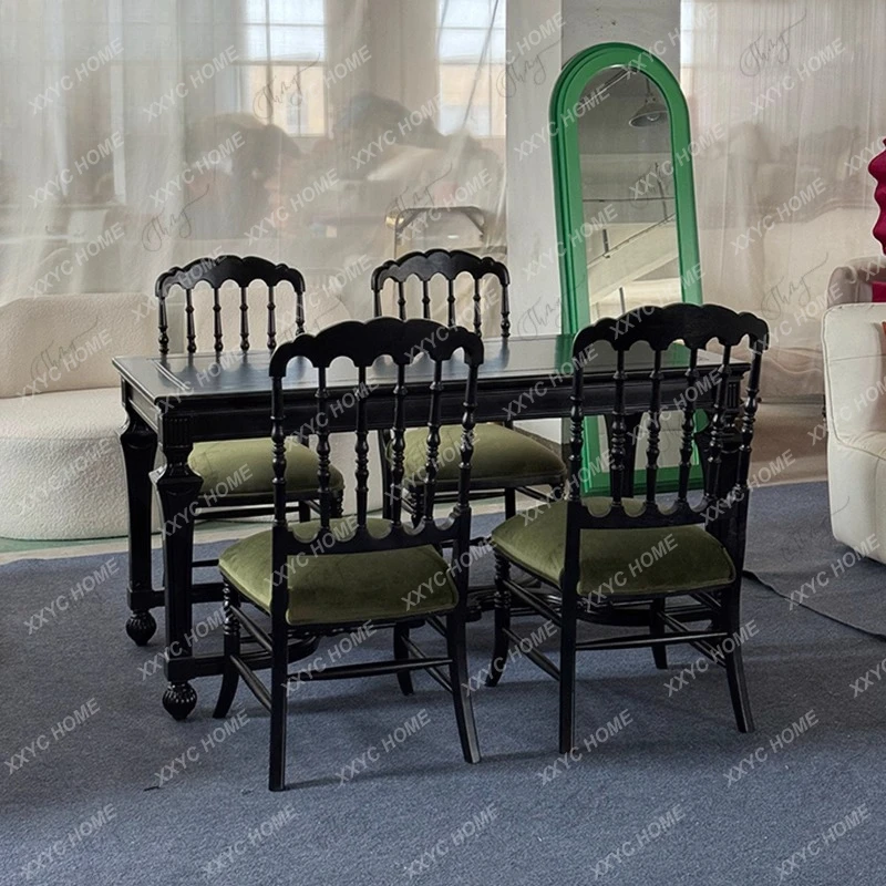 A  solid wood dining table and chairs combination black carved rectangular dining table complete