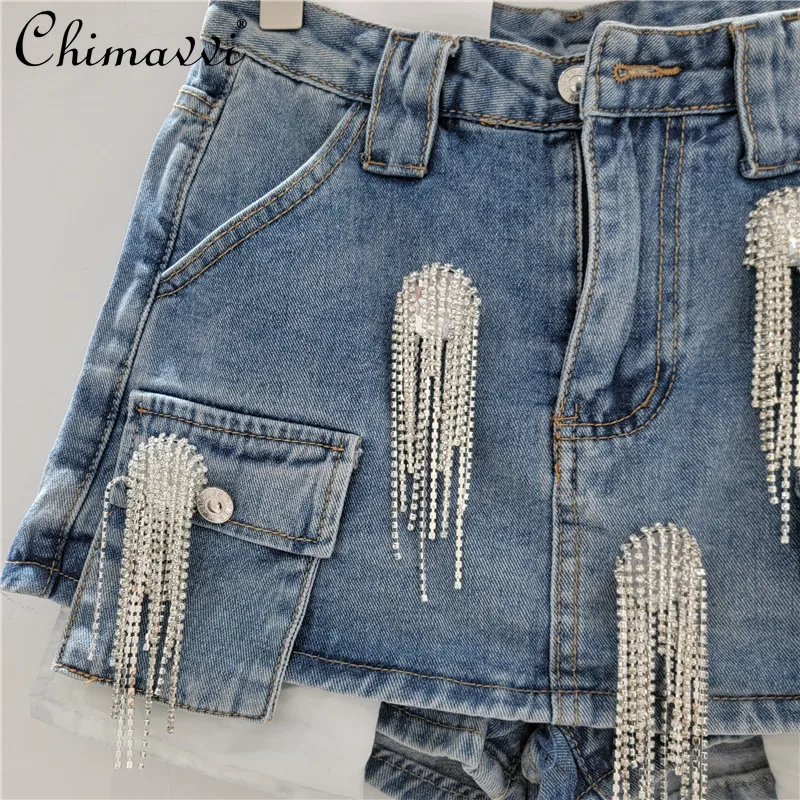 Primavera y novedad de verano, ropa de calle corta de manga larga con flecos, chaqueta vaquera perforada, Falda corta, conjunto de falda de moda de 2 piezas para mujer