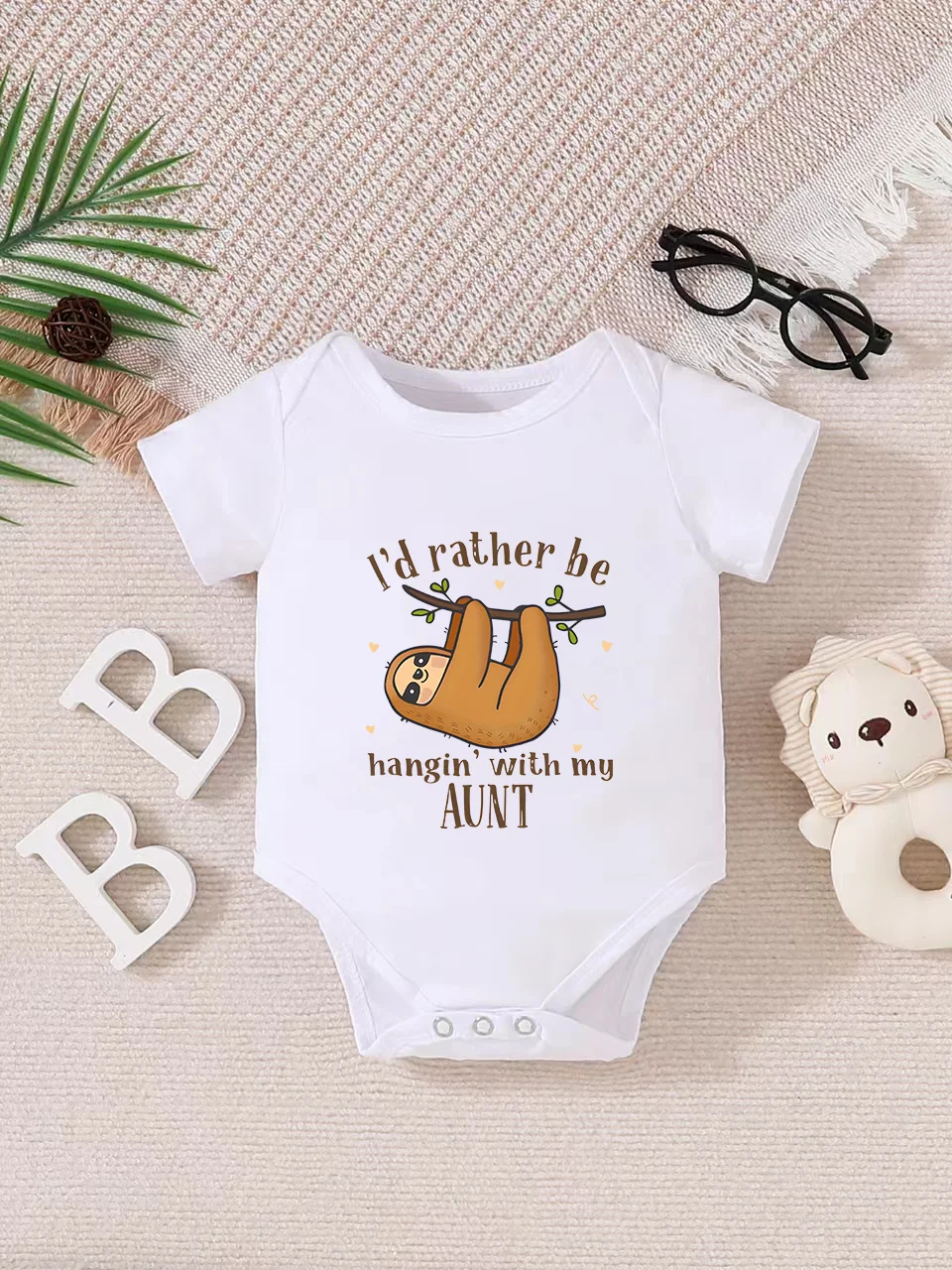 Playful letter-printed baby short-sleeve triangle bodysuit. Button closure for easy dressing, machine washable