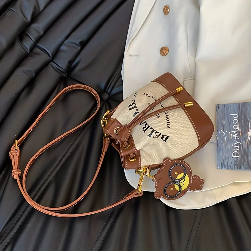 Chic Canvas Bucket Bag with Letter Design - Crossbody & Shoulder Style with Pendant, Drawstring Closure for Everyday Use