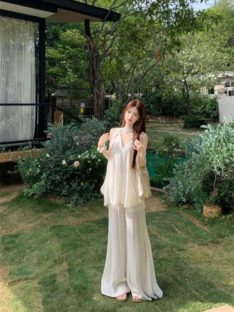 

Trendy Women’s Sleeveless Halter V Neck Blouse with Ruffle Long Pants Summer Fashion Set Unique Design