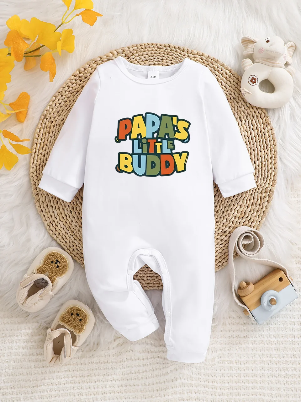 A baby long-sleeved onesie with interesting letter prints. It features a buttoned design for easy putting on and taking off