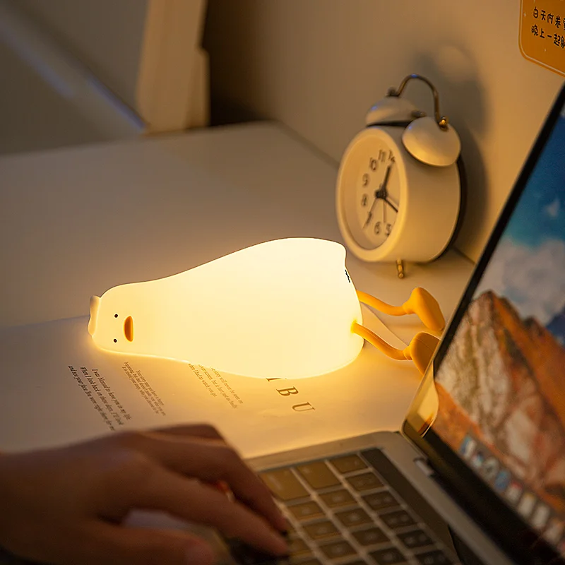 Lying Flat Duck Night Light Silicone Squishy Rechargeable Tap Control 3 Brightness 30 Min Timer Phone Holder for Bedside view 5