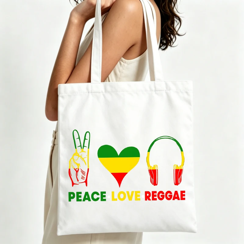 Women's peace sign and heart graphic canvas tote bag with reggae-inspired design, ideal for casual outings and music events