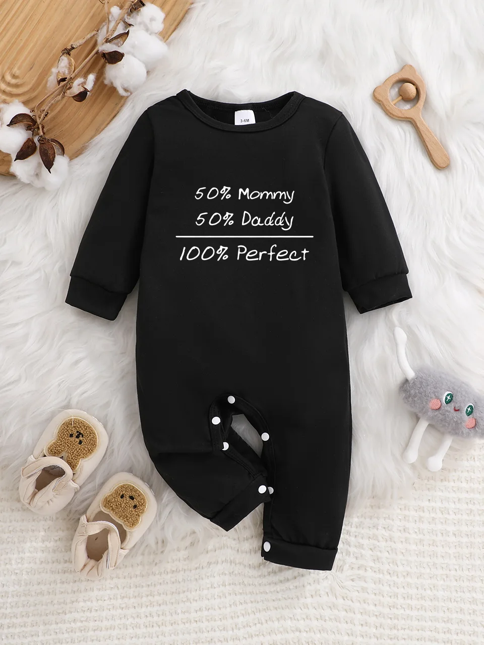 A baby long-sleeved onesie with interesting letter prints. It features a buttoned design for easy putting on and taking off, and