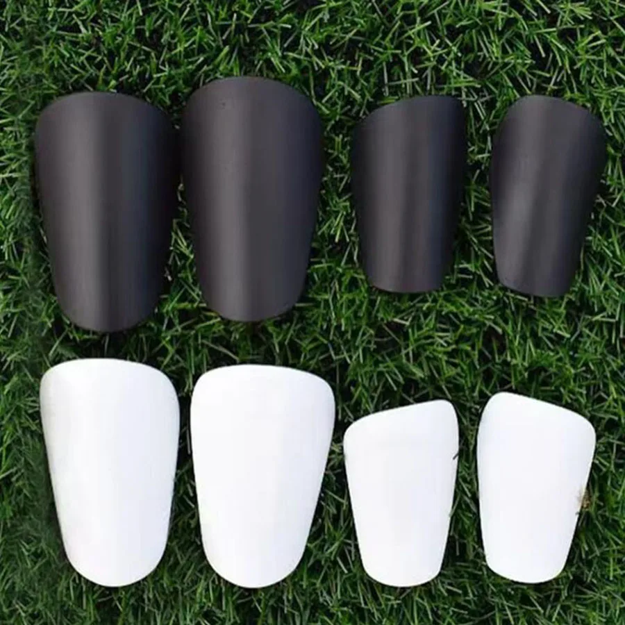 A pair of mini shin guards for soccer training, used as protective gear for the shins and feet.